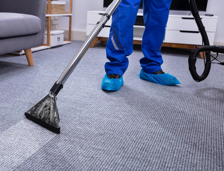 Technician using a carpet extractor to deep clean office flooring